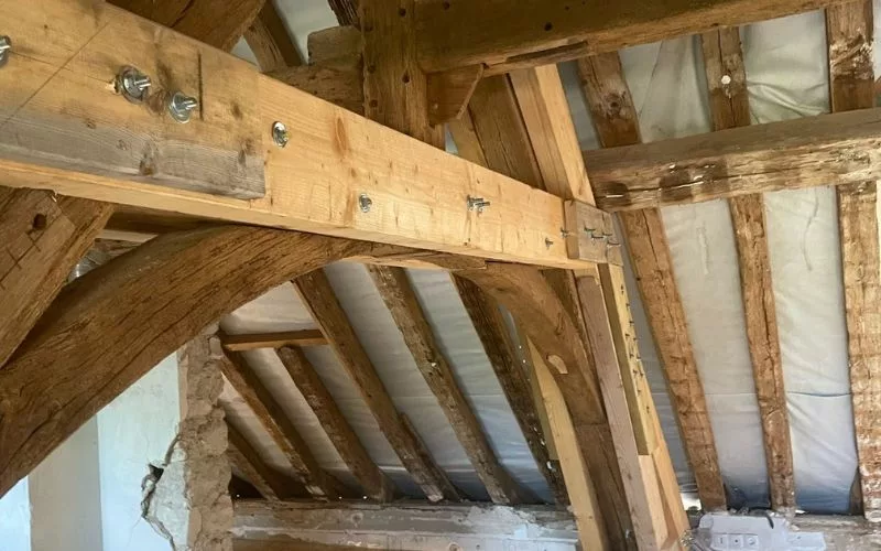 Renfort d’une ferme de charpente ancienne découvert après ouverture sur une toiture de château